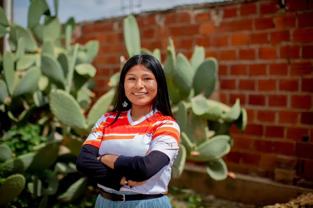 Nadeyli from Bolivia smiles and stands confidently.