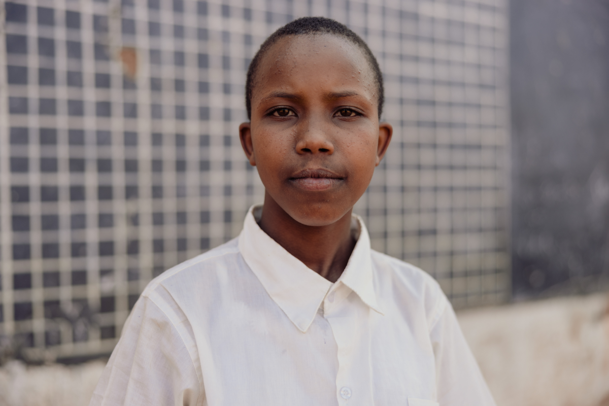 A serious portrait of Glory dressed in her school uniform.