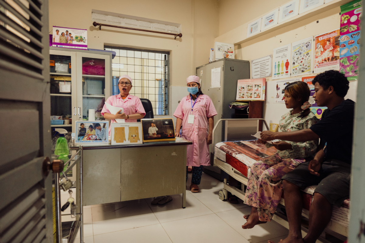 Midwife Vannak and other medical staff present health education for children in an examination room.