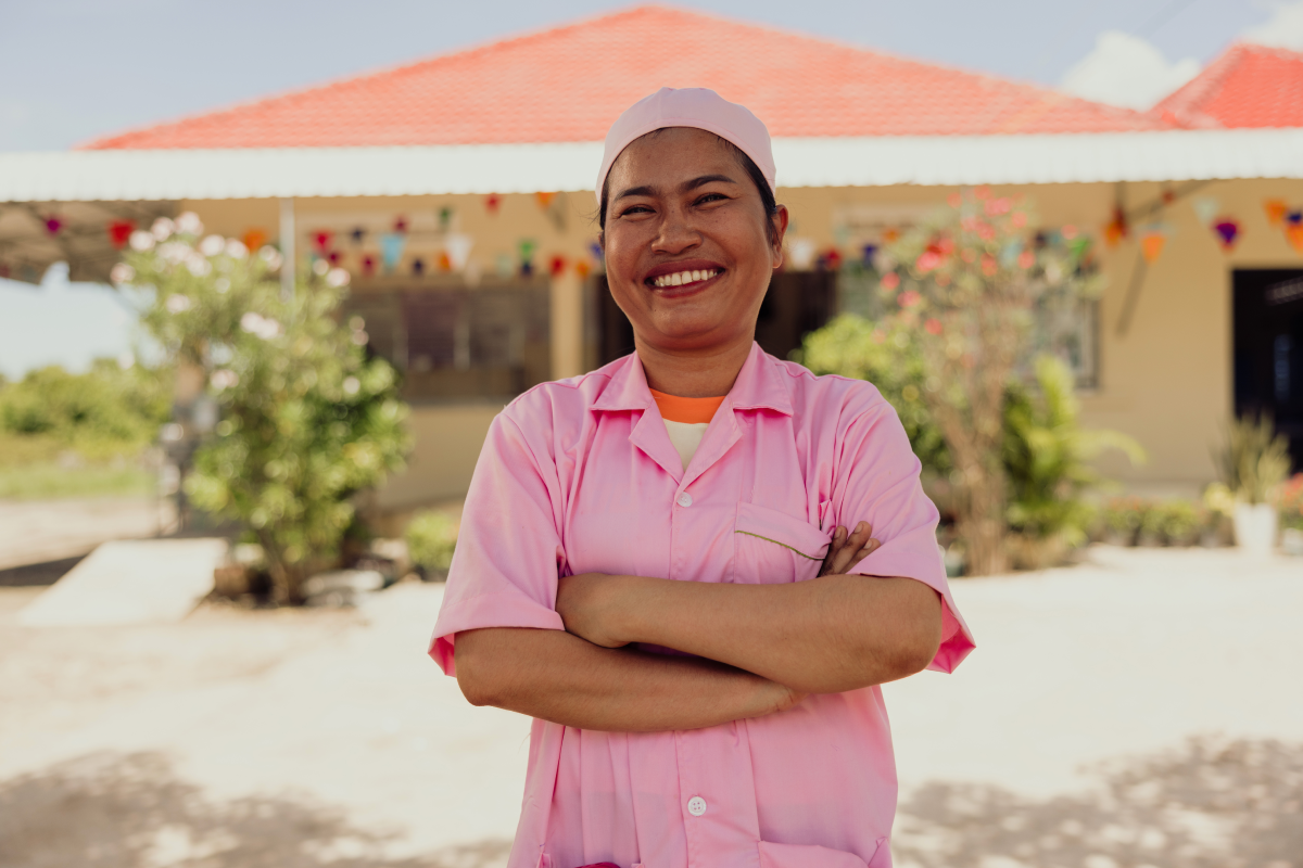 Vannak, a former sponsored child, stands proudly as a midwife at the Svay Rumpear Health Centre in Kampong Leaeng, Cambodia.